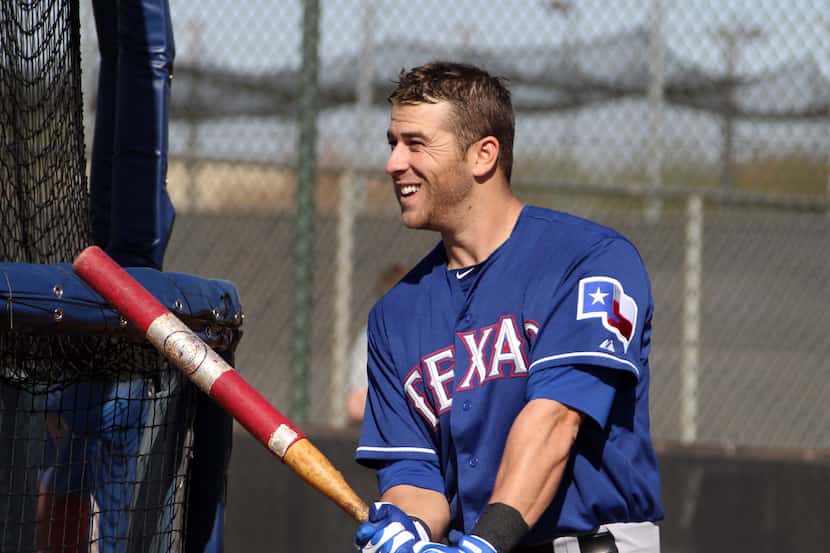Texas infielder Mike Olt gets ready to hit in the cage during batting practice at the Texas...