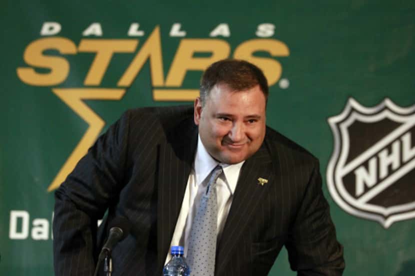 Tom Gaglardi gets up as he is introduced as the new owner of the Dallas Stars during a news...
