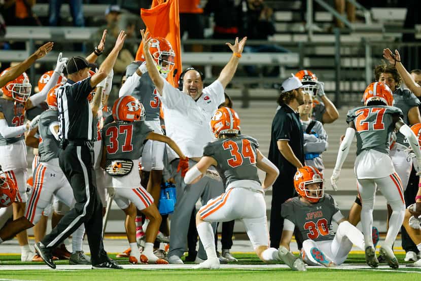 The Rockwall sideline celebrates after recovering an onside kick during the first half of a...