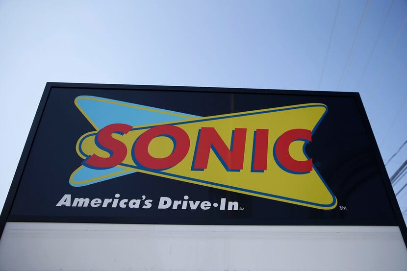 FILE- This March 9, 2015, file photo shows a sign for a Sonic Drive-In in Holmes, Pa. Arby's...