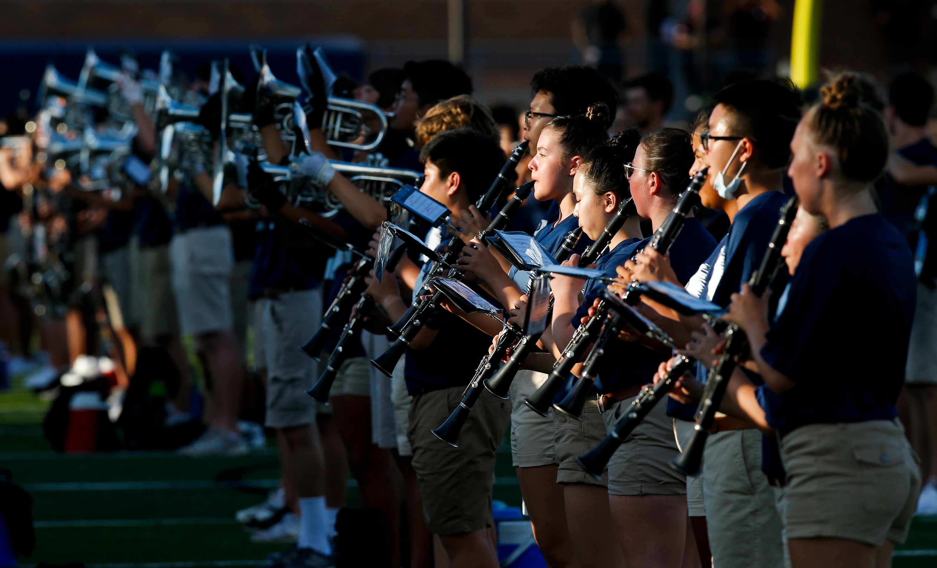 Flower Mound’s marching band performs before the first half of a high school football game...