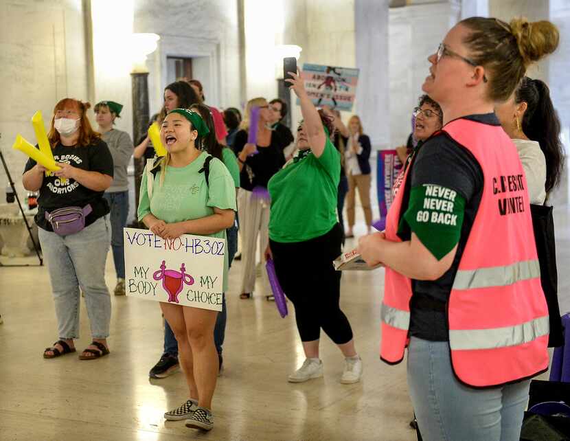 Abortion rights supporters demonstrate outside the Senate chamber at the West Virginia state...