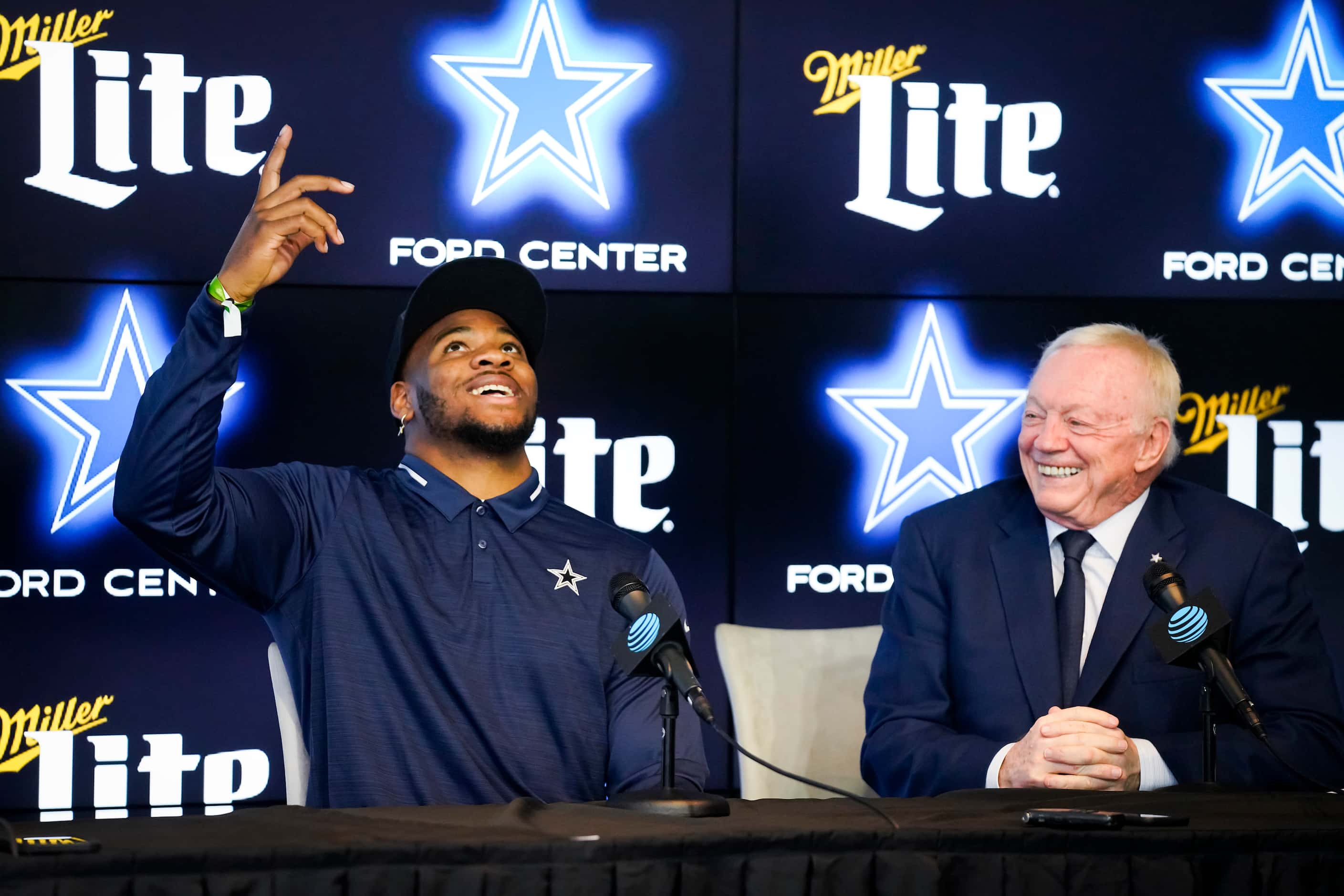 Dallas Cowboys first-round draft pick Micah Parsons points upward as he answers a question...