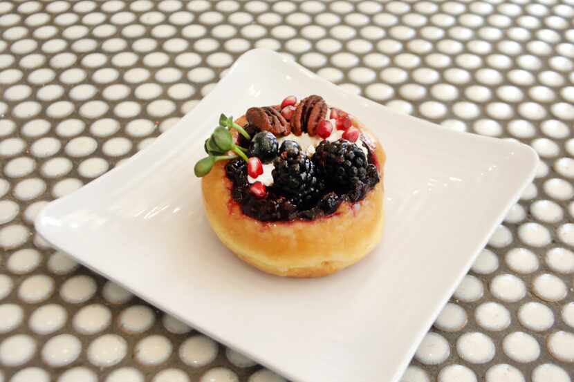 The Midnight Blue doughnut. The doughnut is a vanilla doughnut topped with cream cheese made...