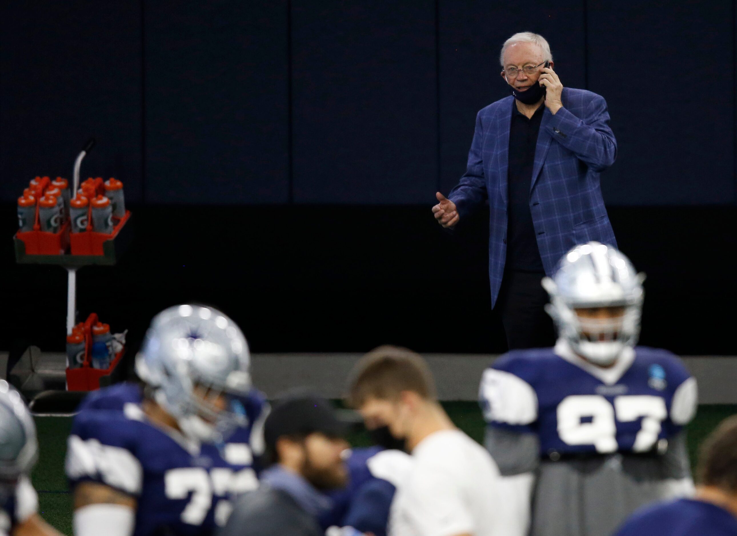 Dallas Cowboys owner and general manager Jerry Jones conducts a radio interview on the phone...