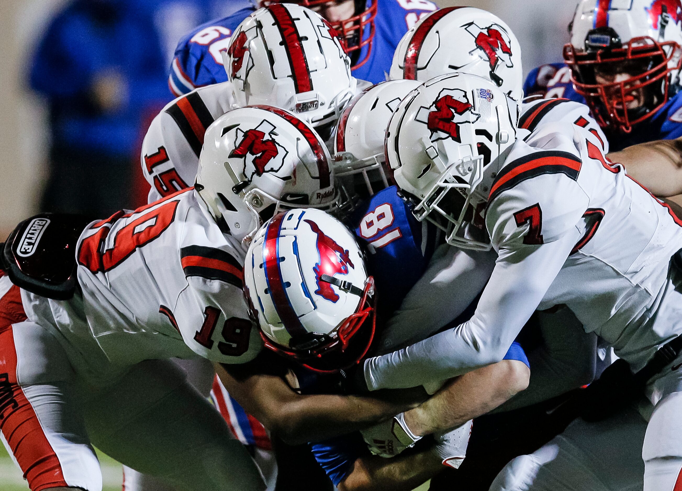 JJ Pearce junior running back Adam Velin (18) battles a host of Irving MacArthur defenders...