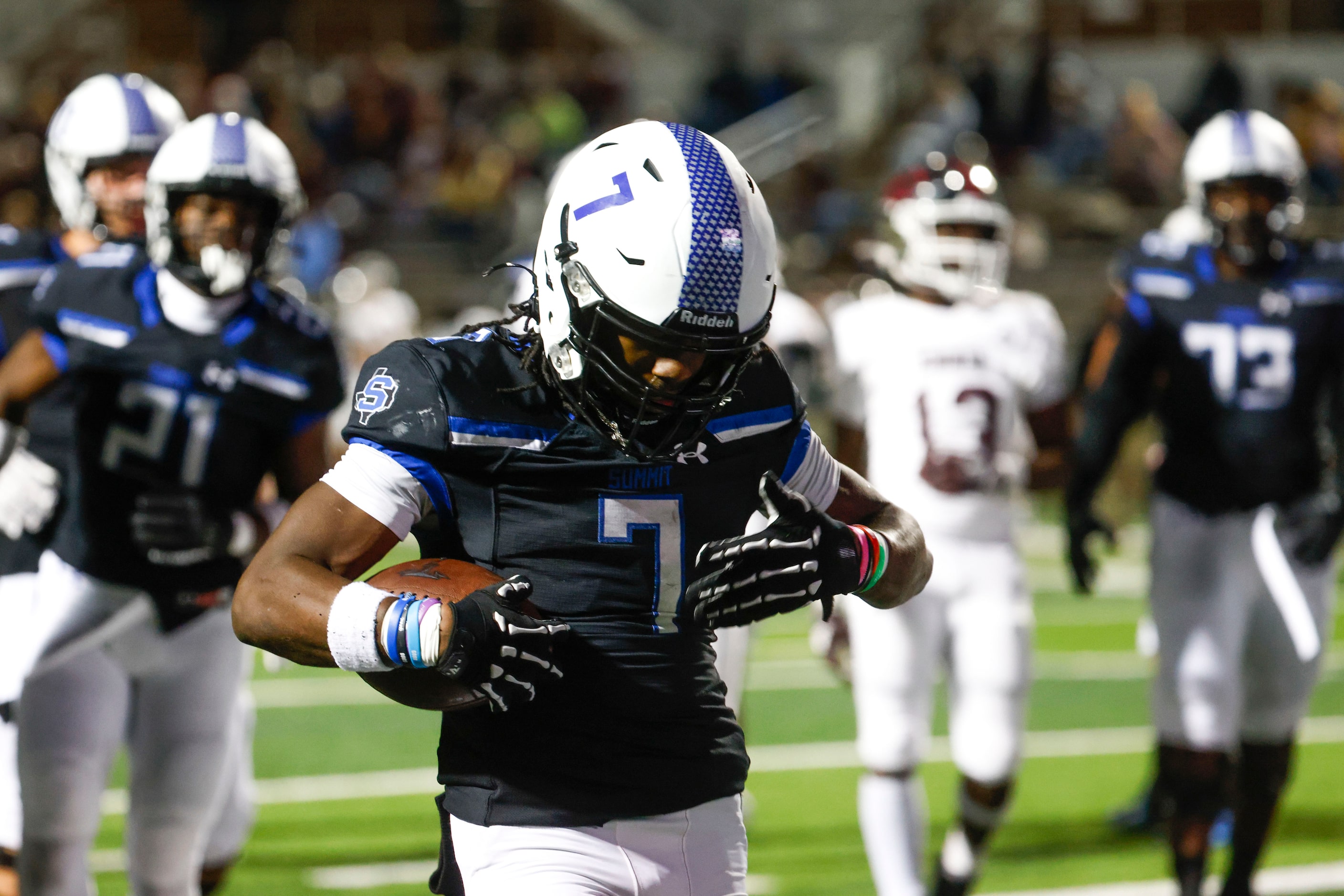 Mansfield Summit High’s Amare Burgess (left) celebrates a touchdown against Ennis High...