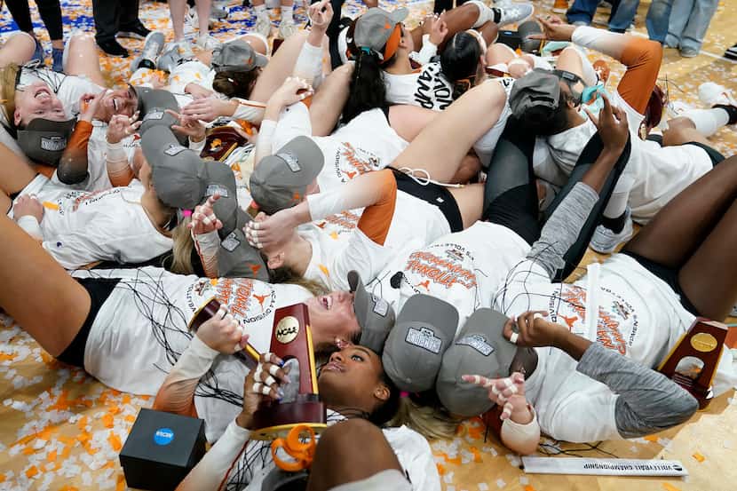 Texas players celebrate after defeating Nebraska during the championship match in the NCAA...