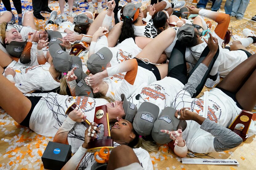 Texas players celebrate after defeating Nebraska during the championship match in the NCAA...