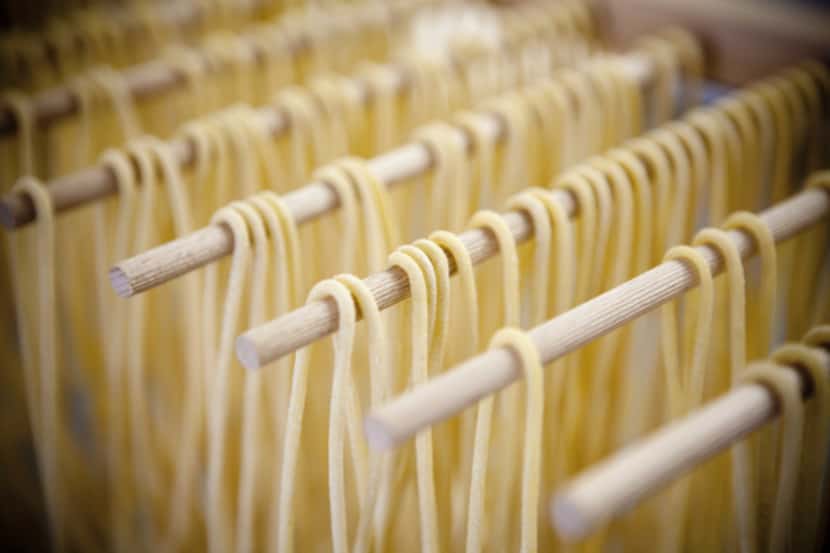 Homemade spaghetti noodles hung out to dry.