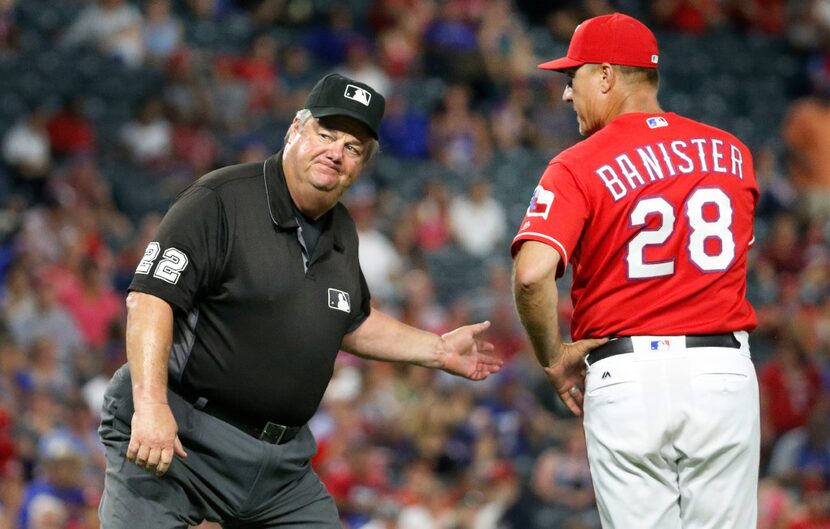 Second base umpire Joe West ejects Texas Rangers manager Jeff Banister (28) as he argues a...