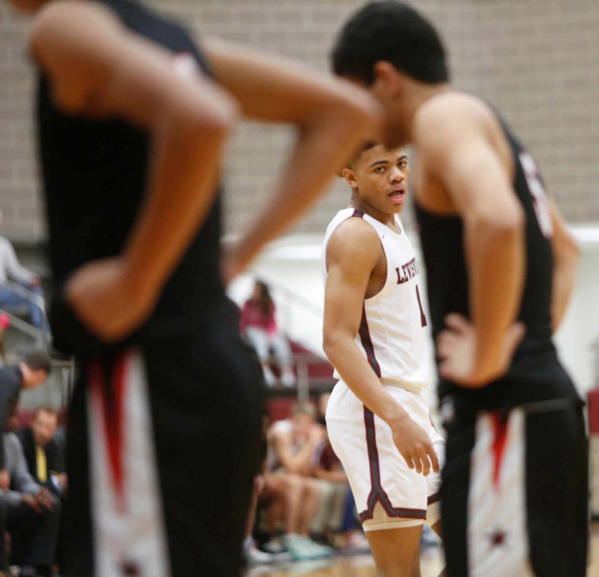 Lewisville's Keyonte George (1) eyes a Coppell player as he makes his way to the free throw...