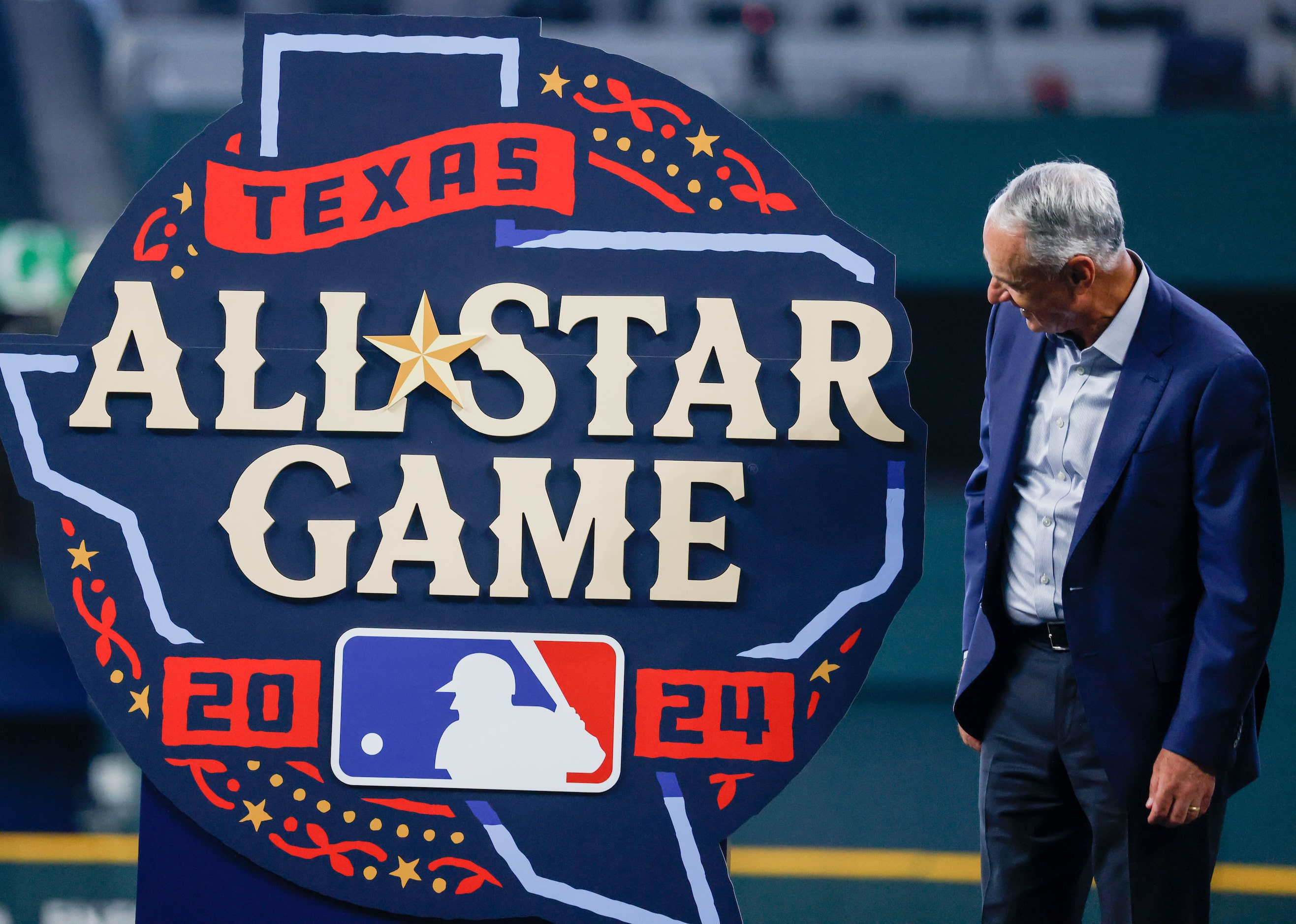 MLB commissioner Rob Manfred smiles as he looks at the official logo after helping to unveil...