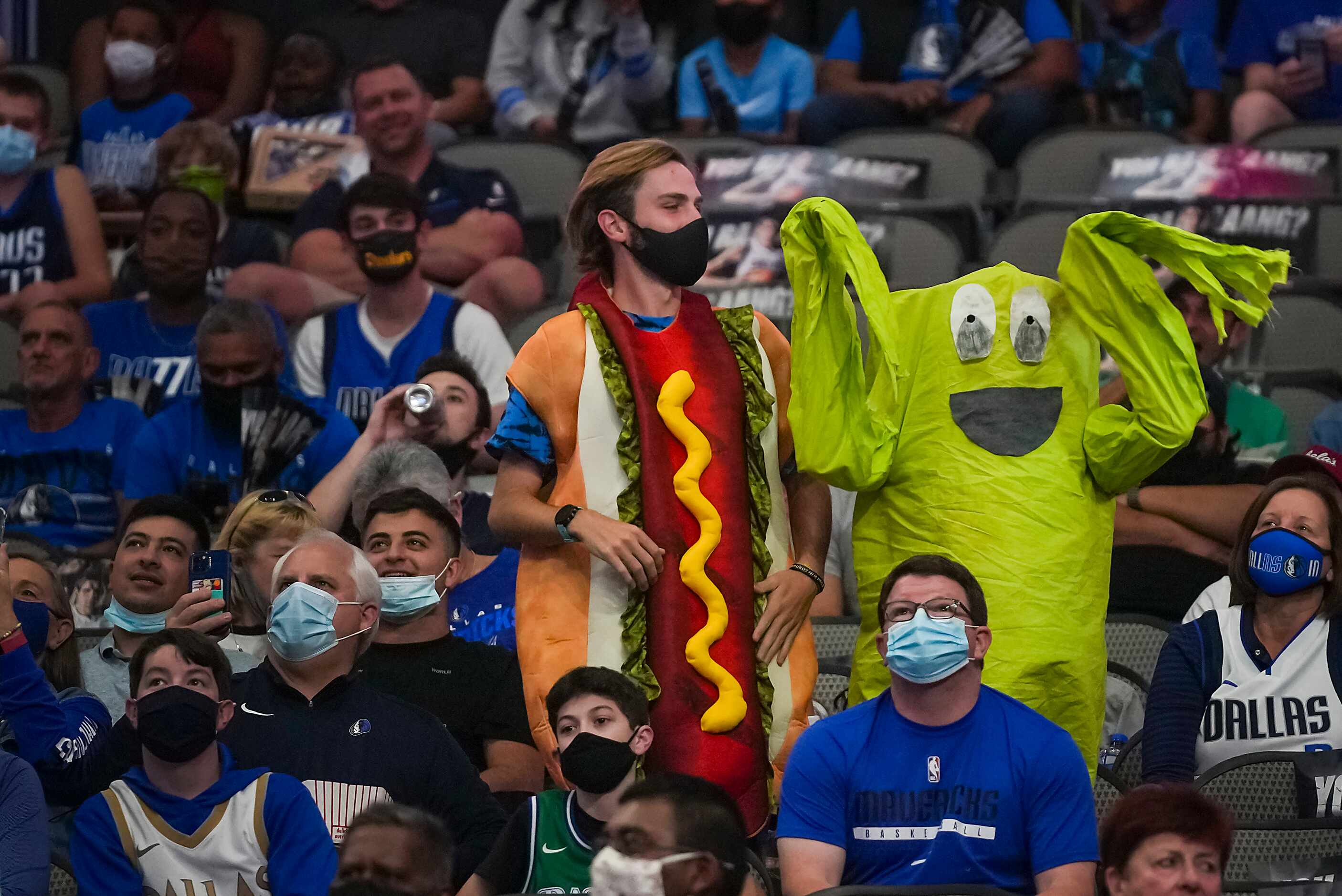 Fans wear Halloween costumes during the first half of an NBA basketball game between the...