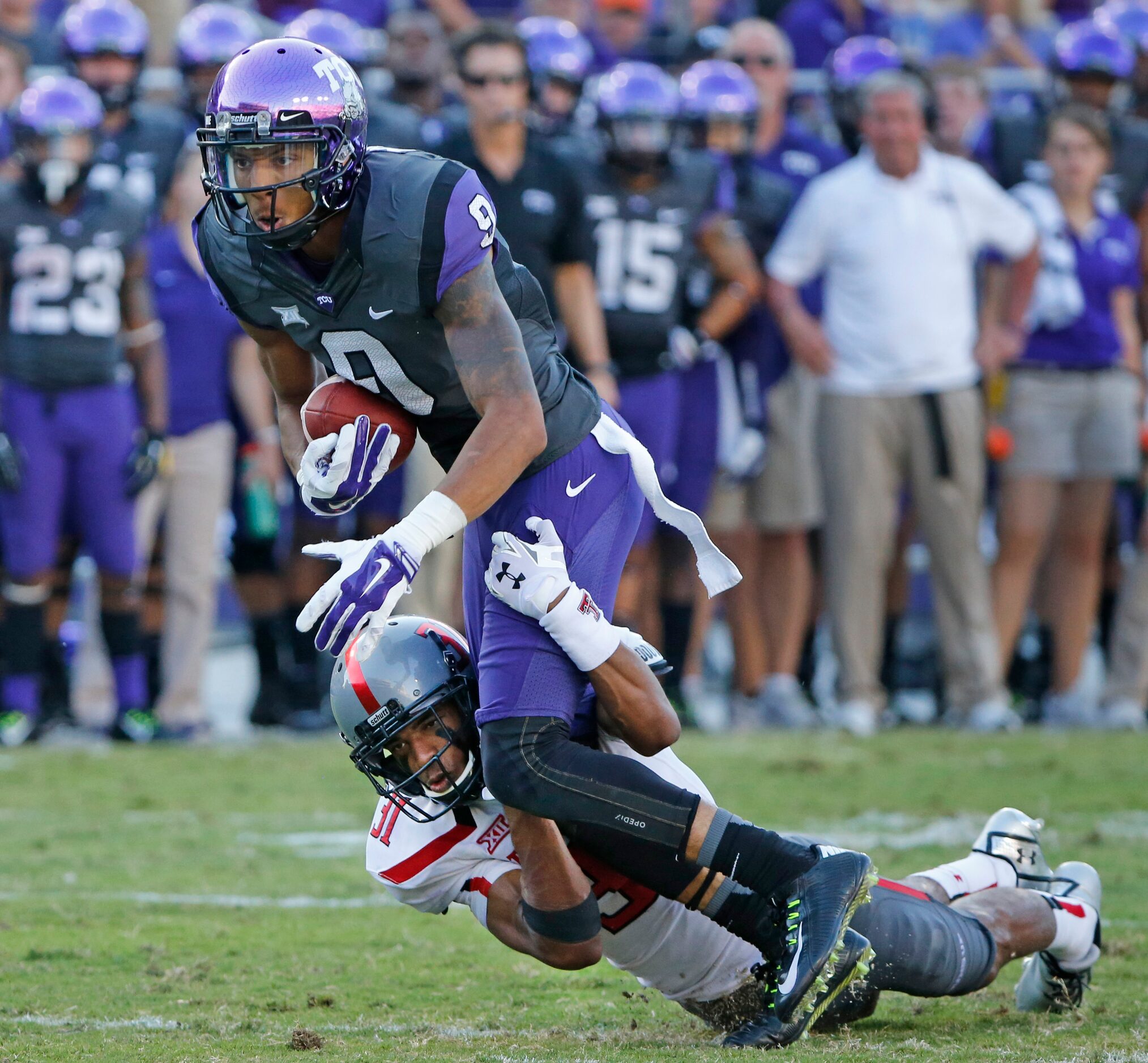 TCU receiver Josh Doctson (9) is hurt after catching a pass, as he is tackled by Texas Tech...