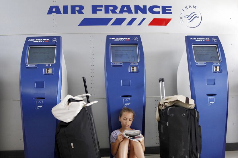 A girl reads as she waits for a flight at the Fort-de-France Aime Cesaire airport in Le...