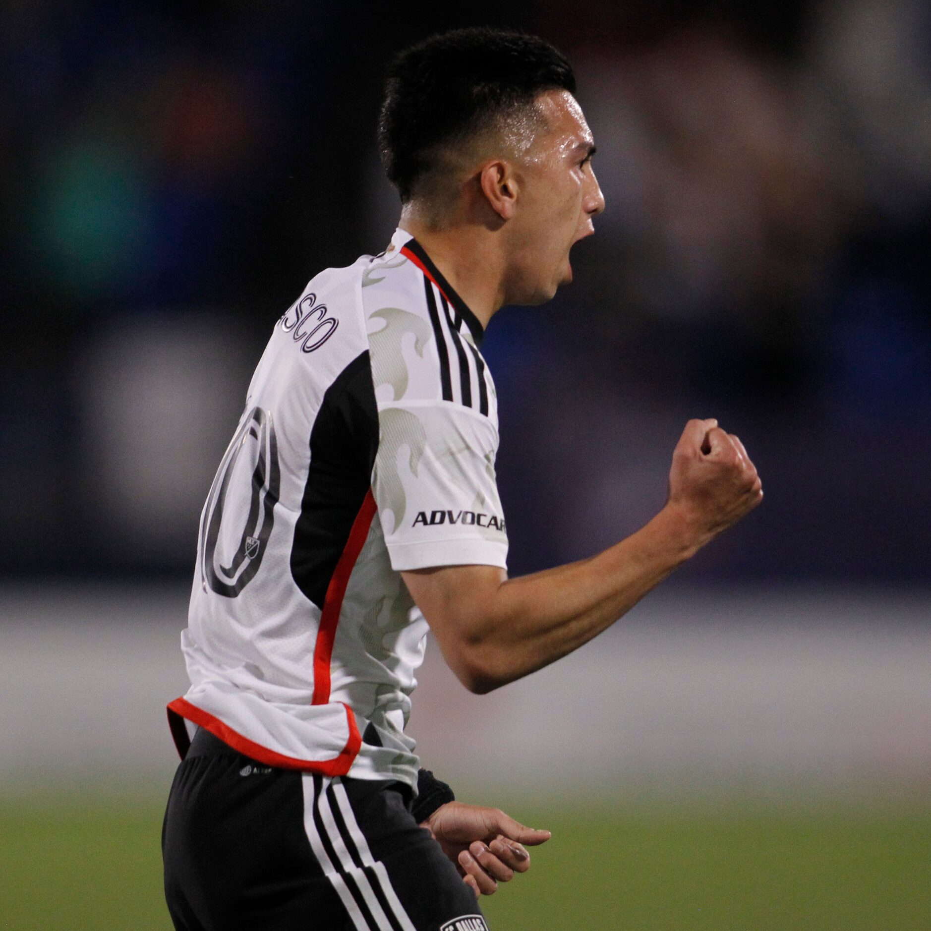 FC Dallas midfielder Alan Velasco (20) lets out a yell after scoring during the first half...