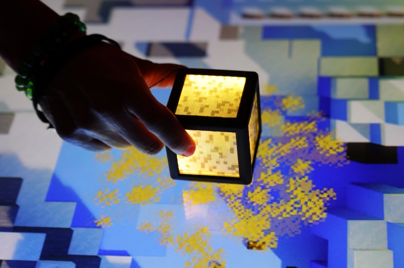 The touch of a cube to the surface activates a burst of colorful designs. Minecraft...