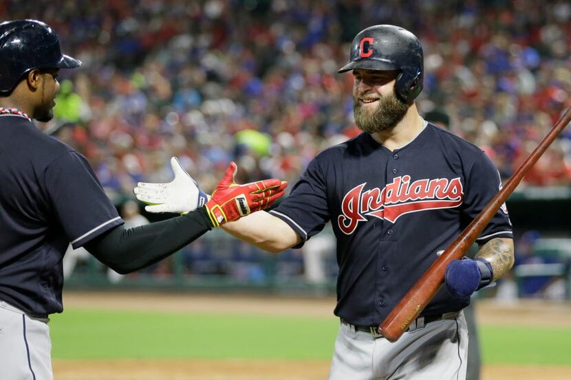 Cleveland Indians' Mike Napoli, right, celebrates with teammate Rajai Davis after scoring on...