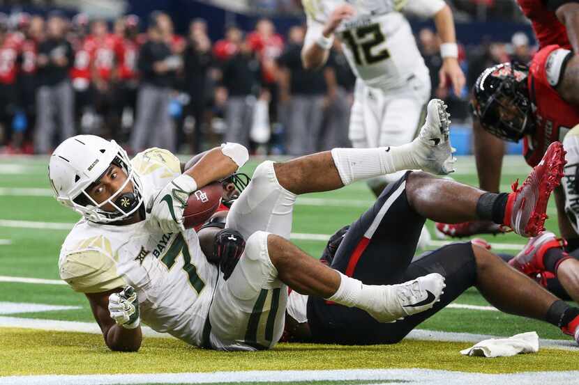 FILE - Baylor Bears running back John Lovett (7) scores a touchdown during a matchup between...