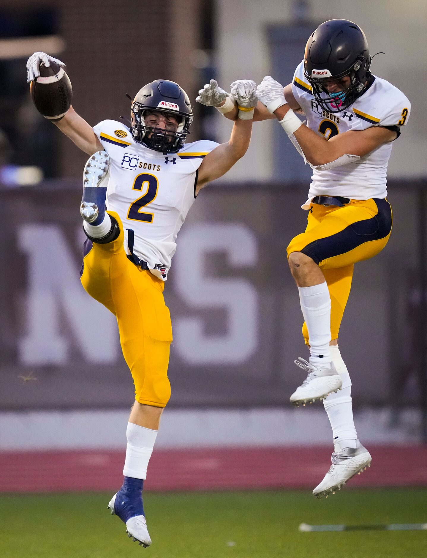 Highland Park wide receiver Grayson Schrank (2) celebrates with Jackson Heis (3) after...