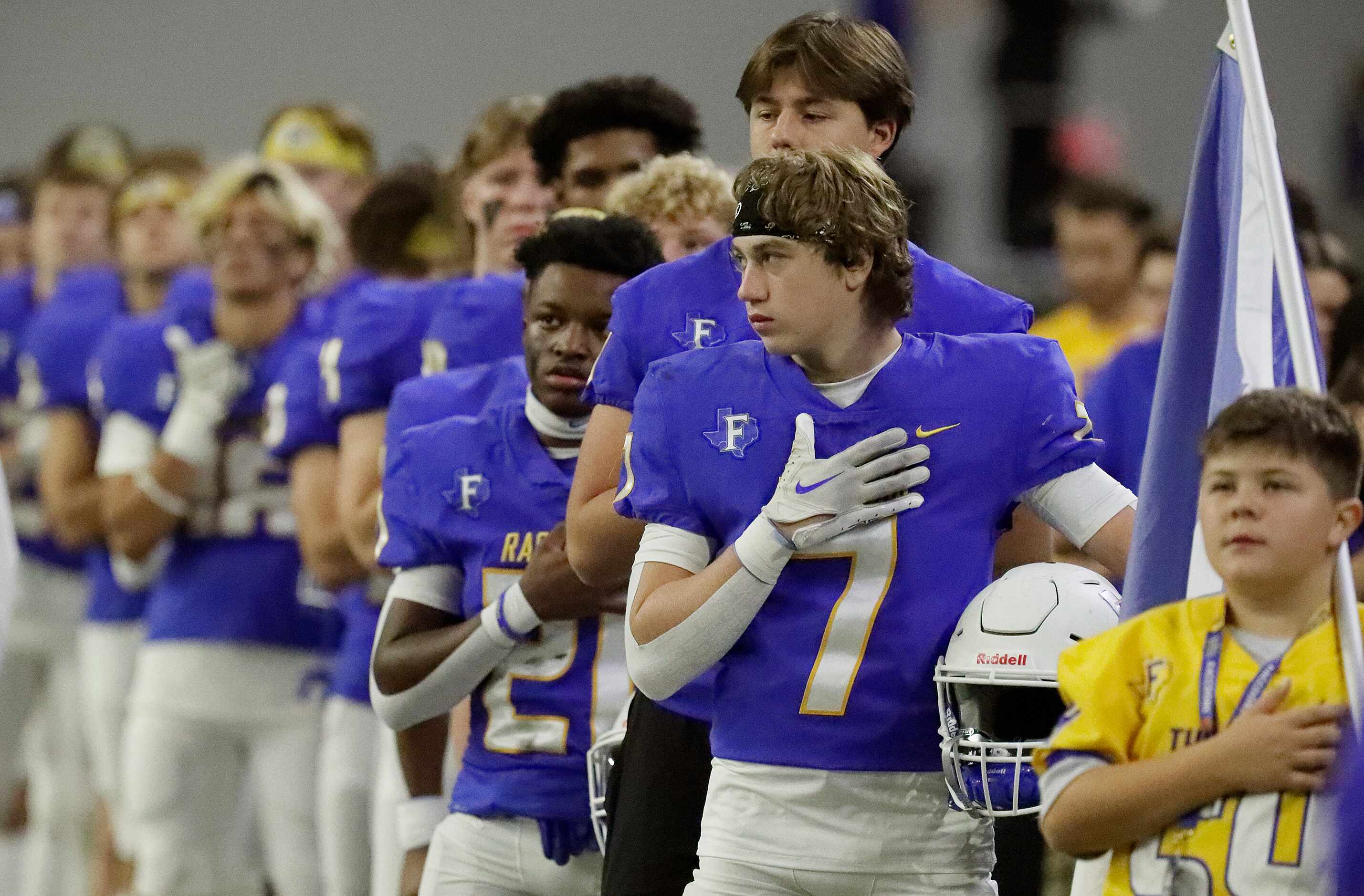 Frisco High School wide receiver Ian Staley (7) waits for the national anthem to play before...