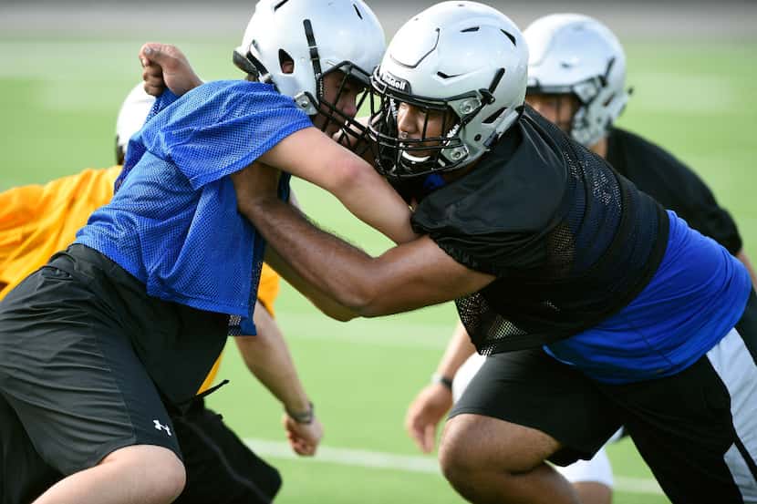 Caption:
Guyer defensive tackle Arian Baht, right, tries to tackle a opposing teammate...