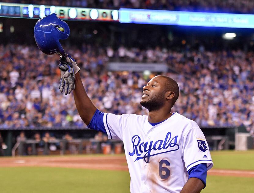 The Kansas City Royals' Lorenzo Cain tips his helmet to the cheering crowd as he comes out...