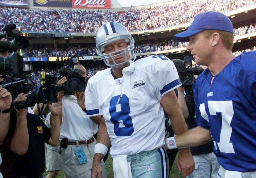 Dallas Cowboys quarterback Troy Aikman is consoled by New York quarterback and former Cowboy...