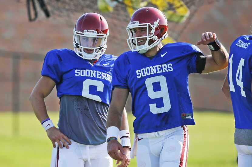 Oklahoma quarterbacks Baker Mayfield, left, and Trevor Knight (9) talk during an Oklahoma...