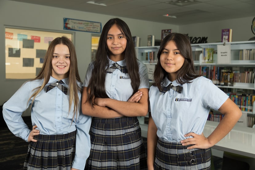 students wearing school uniforms in classroom