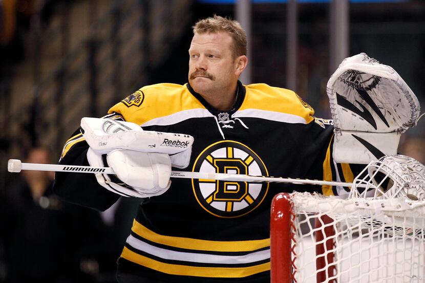 In this February 2012 photo, Boston Bruins goalie Tim Thomas gets ready for an NHL hockey...