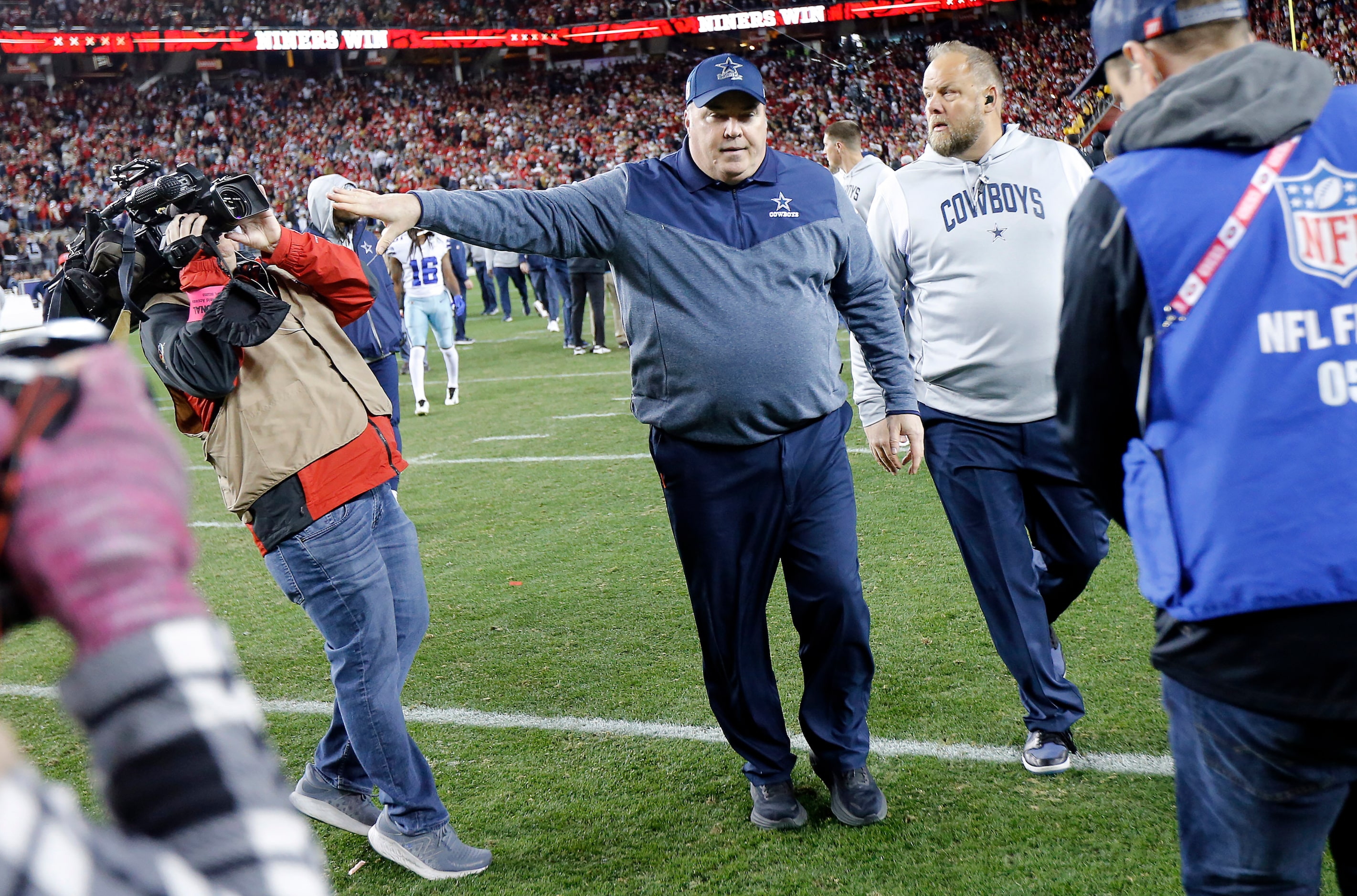 Dallas Cowboys head coach Mike McCarthy shoves KXAS (Dallas) photojournalist Noah Bullard as...