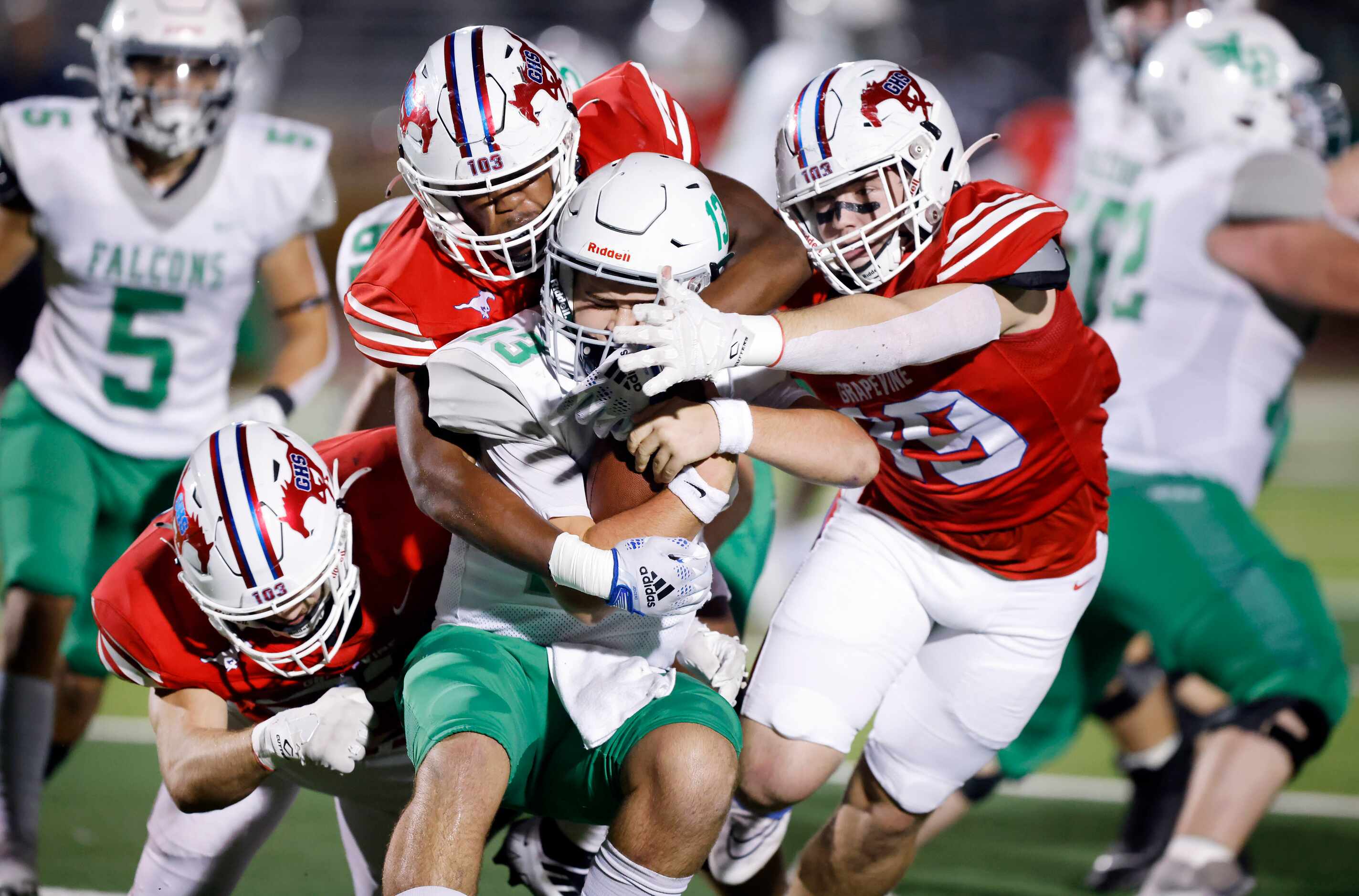 Lake Dallas quarterback Cade Bortnem (13) is sacked by a trio of Grapevine defenders during...