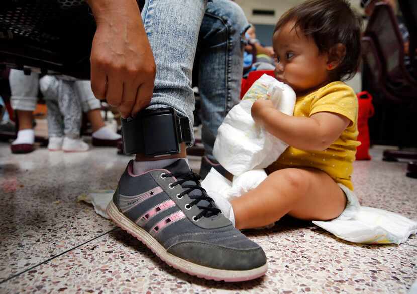 Damaris Gonzalez, 20, of Guatemala shows her ankle monitor that was attached by U.S. Border...