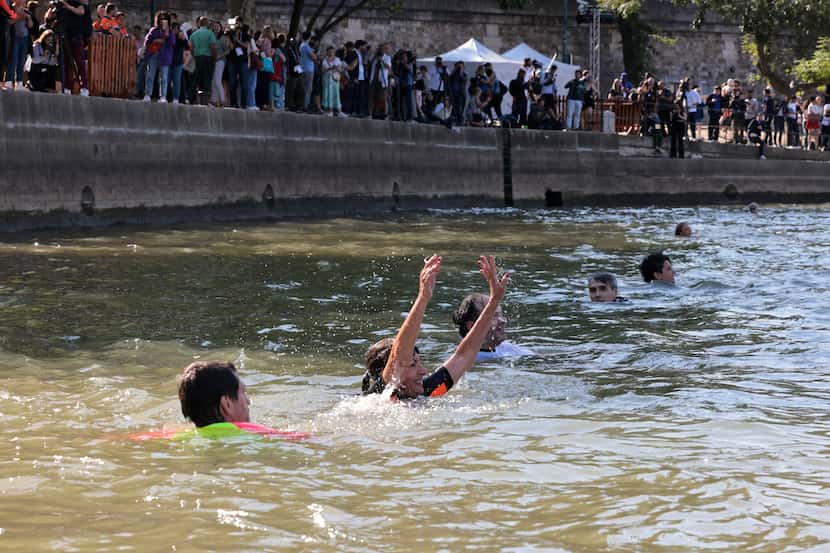 Paris Mayor Anne Hidalgo, center, swims in the Seine river, Wednesday, July 17, 2024 in...
