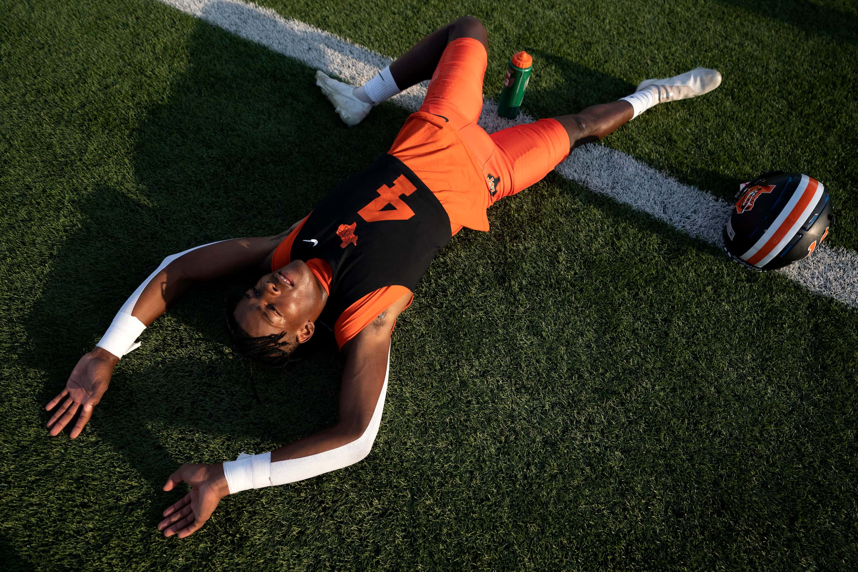 Lancaster wide receiver Dwight Jones (4) stretches before a high school football game...
