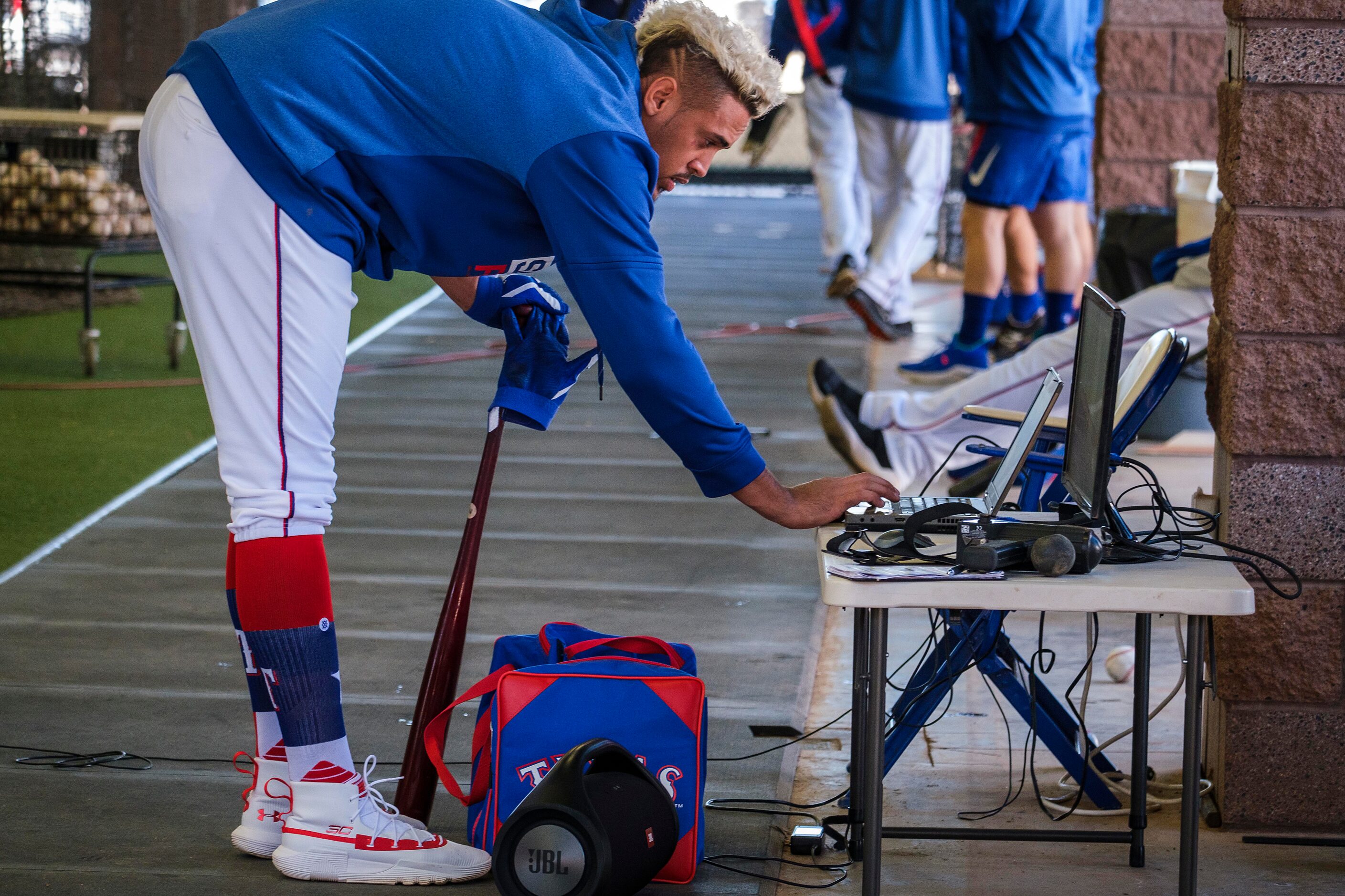 Texas Rangers infielder Ronald Guzman reviews video in the batting cages during a spring...