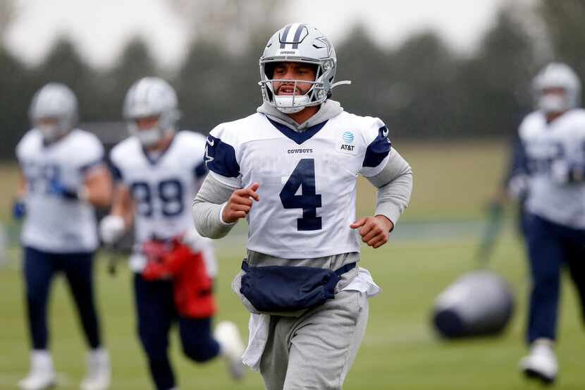 Dallas Cowboys quarterback Dak Prescott (4) warms up with the team during practice at The...