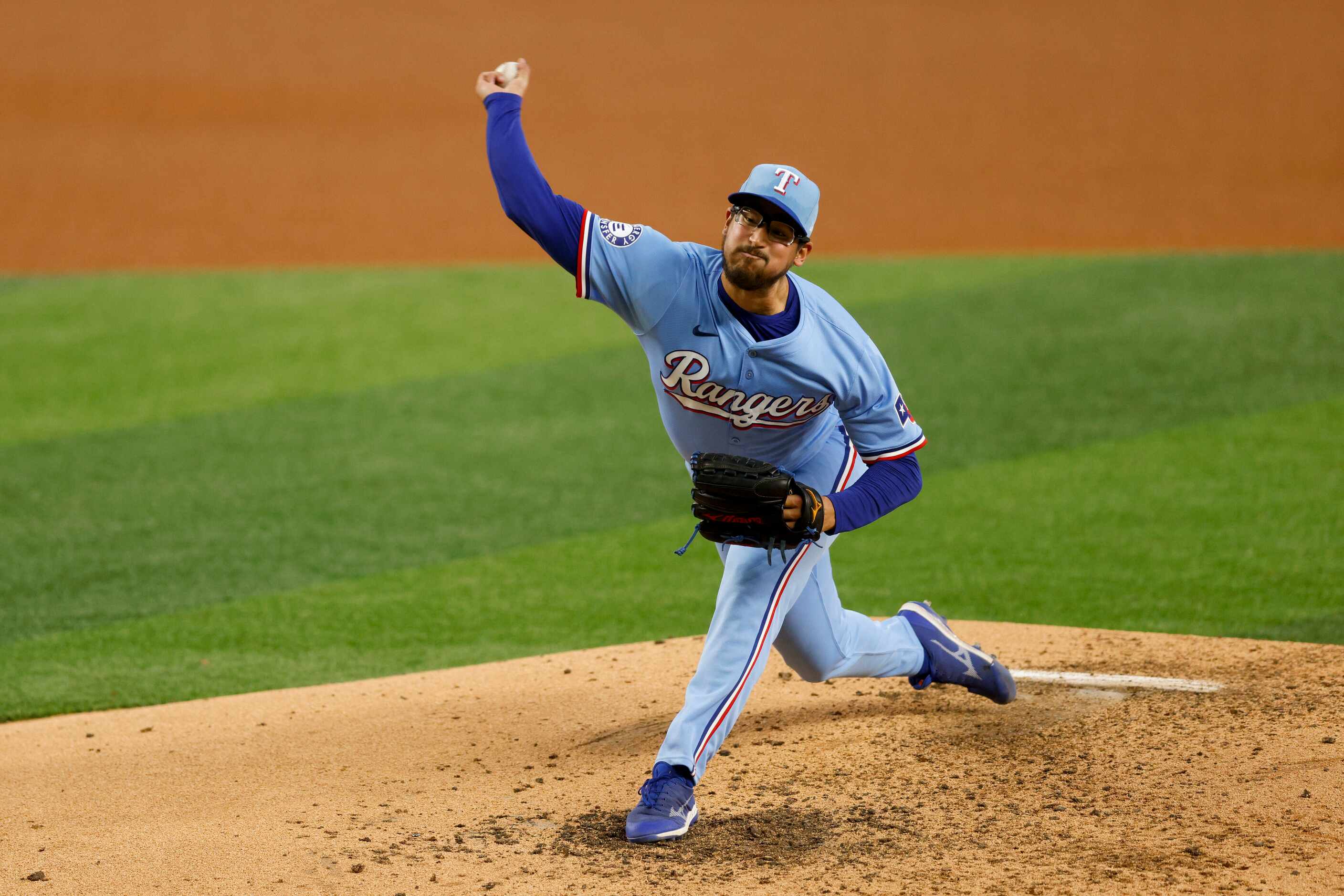 Texas Rangers pitcher Dane Dunning (33) delivers during the seventh inning against the...