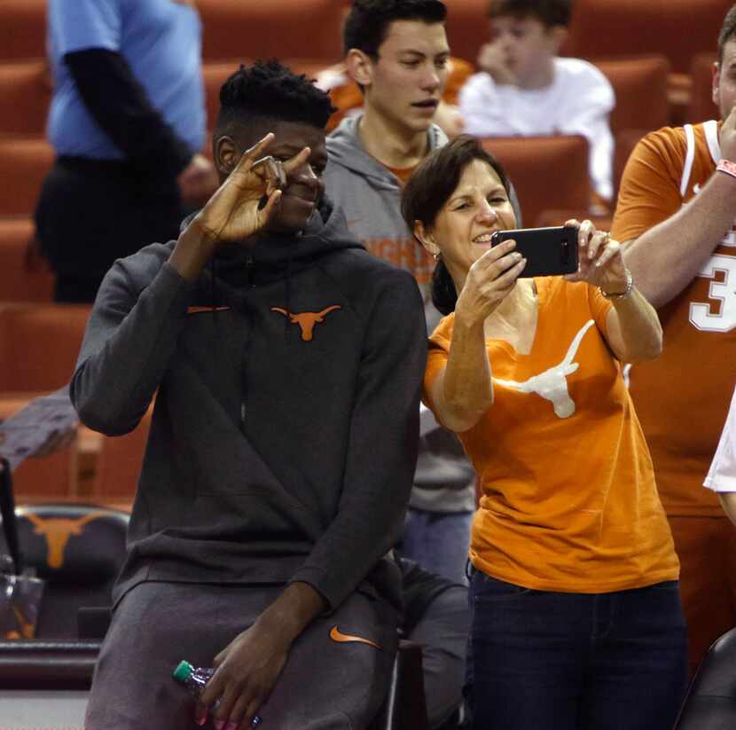 Texas center Mohamed Bamba, left, has his picture taken with a Texas fan before an NCAA...