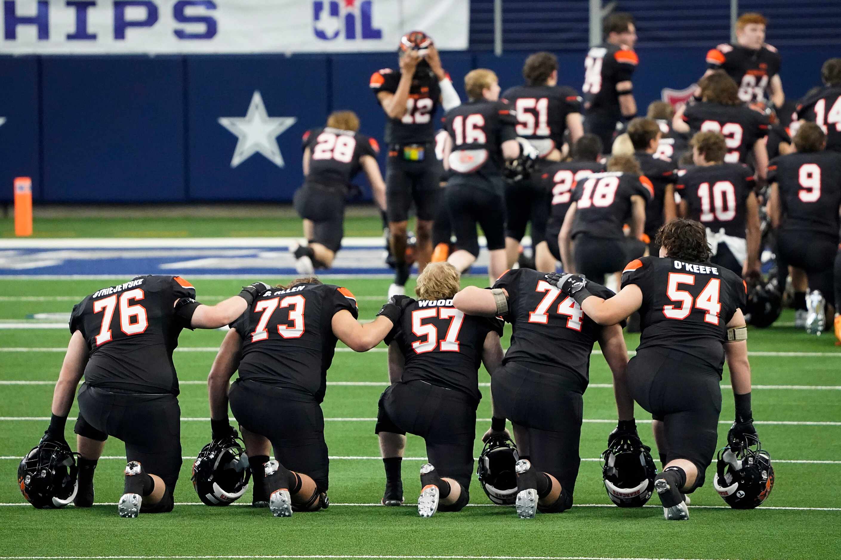 Aledo players kneel in prayer before the first half of the Class 5A Division II state...
