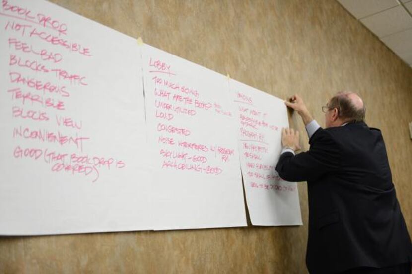 
Bill Hidell, of Hidell and Associates Architects, hangs library expansion suggestions from...