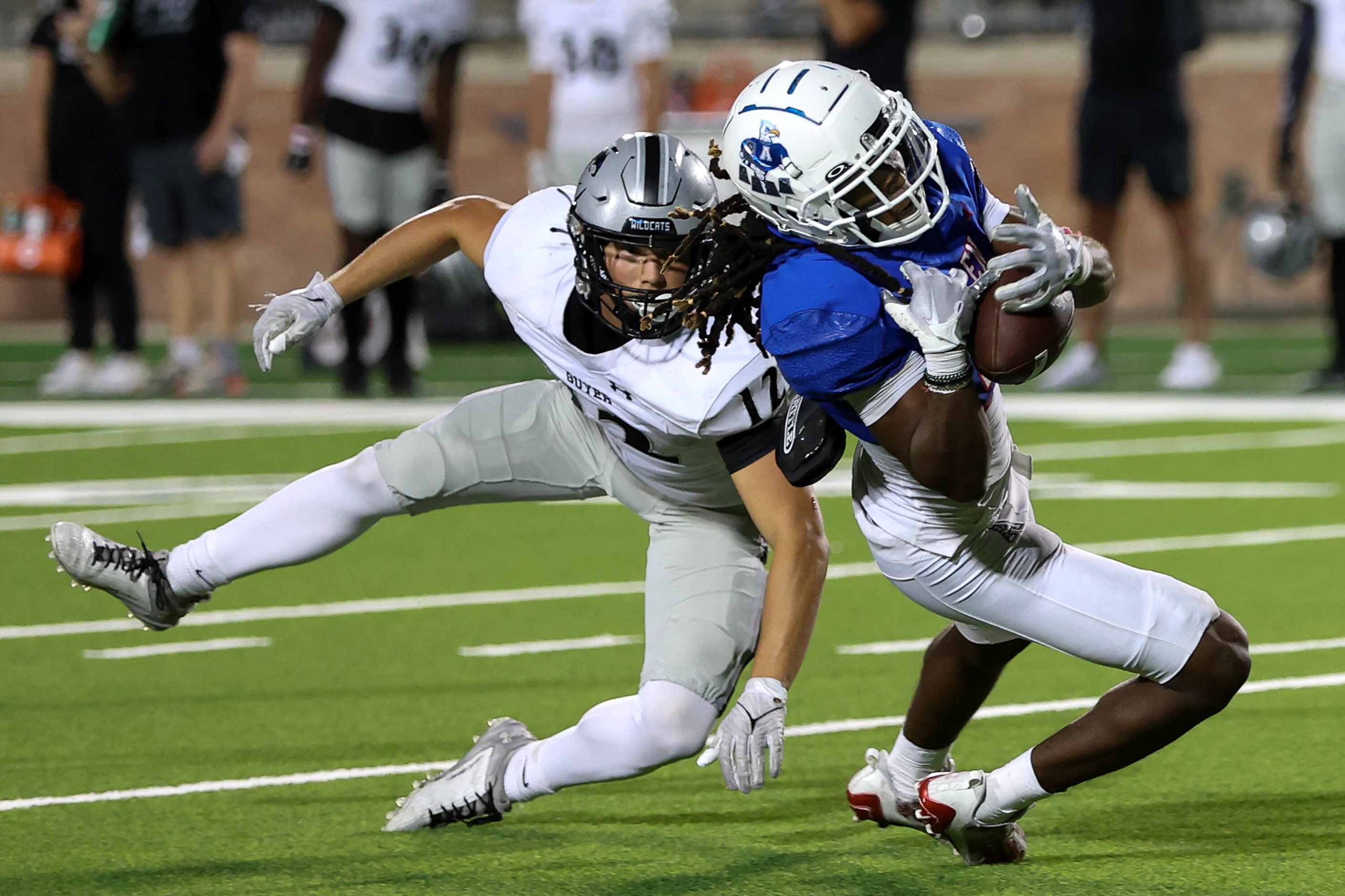 Allen wide receiver Messiah Washington (4) hangs on to a 35 yard reception against Denton...