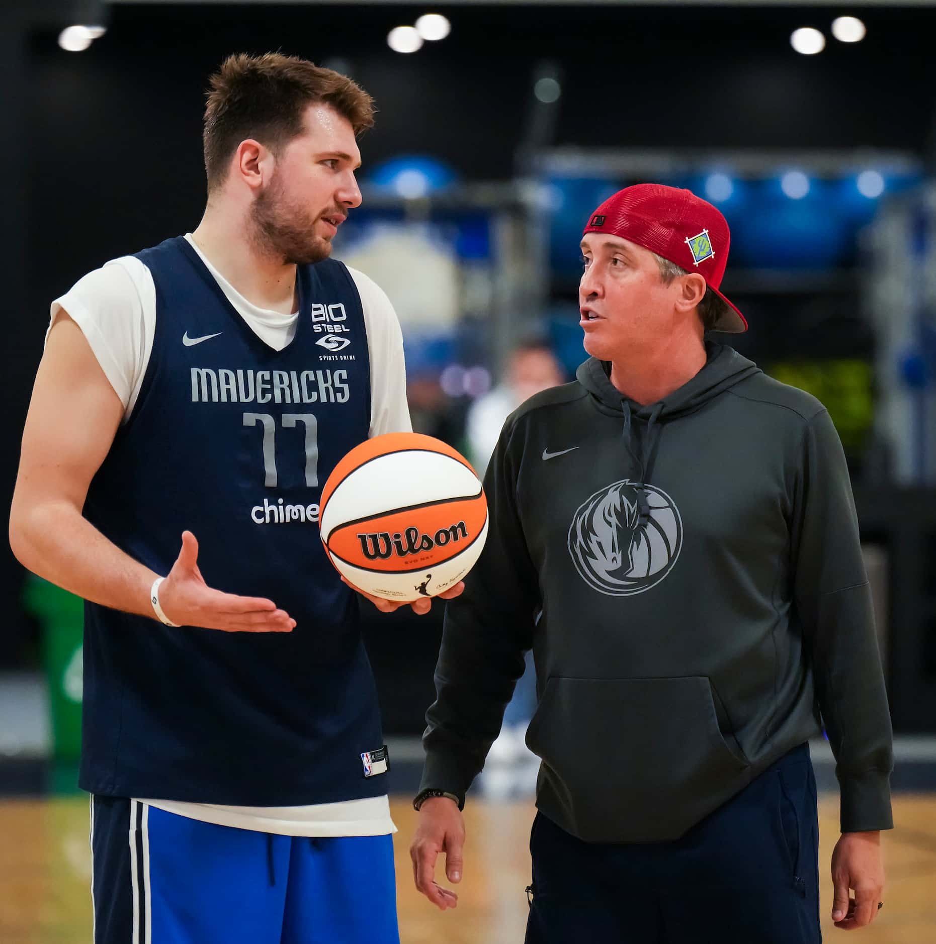 Dallas Mavericks guard Luka Doncic talks with Casey Smith, director of player health and...