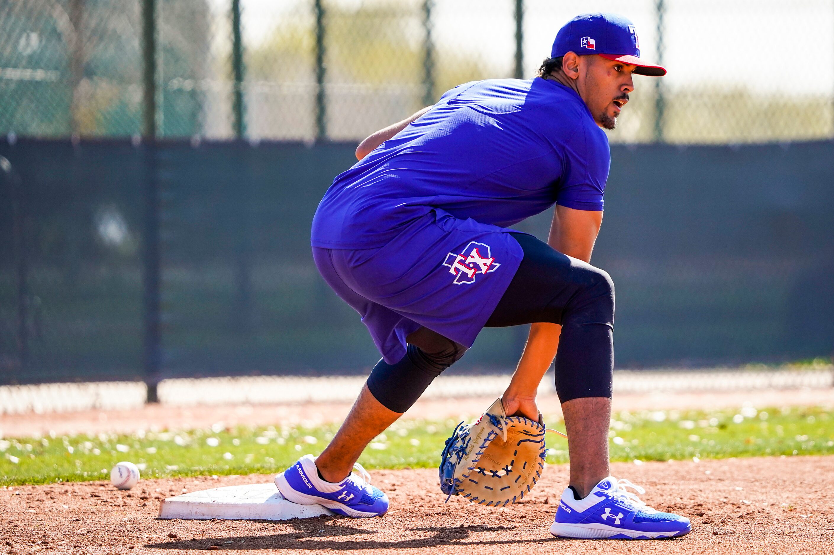 Texas Rangers first baseman Ronald Guzman takes infield practice during a training workout...