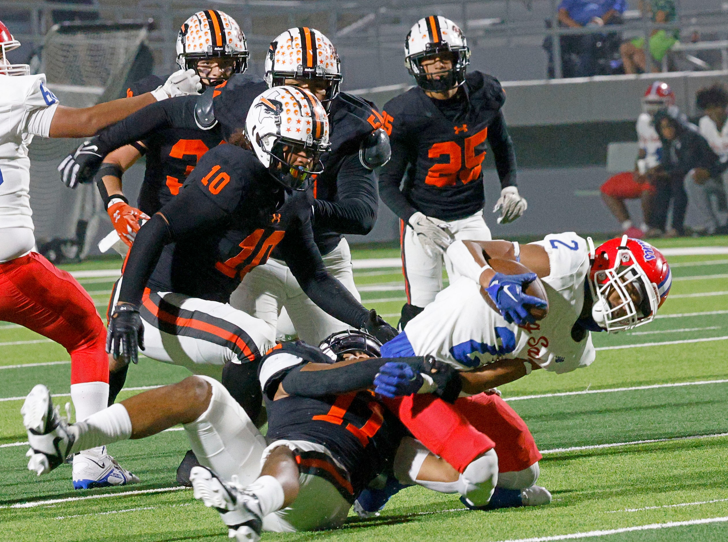 Sam Houston's Jorden Washington (2) is tackled by Haltom's Damien Wayne (11) in the second...