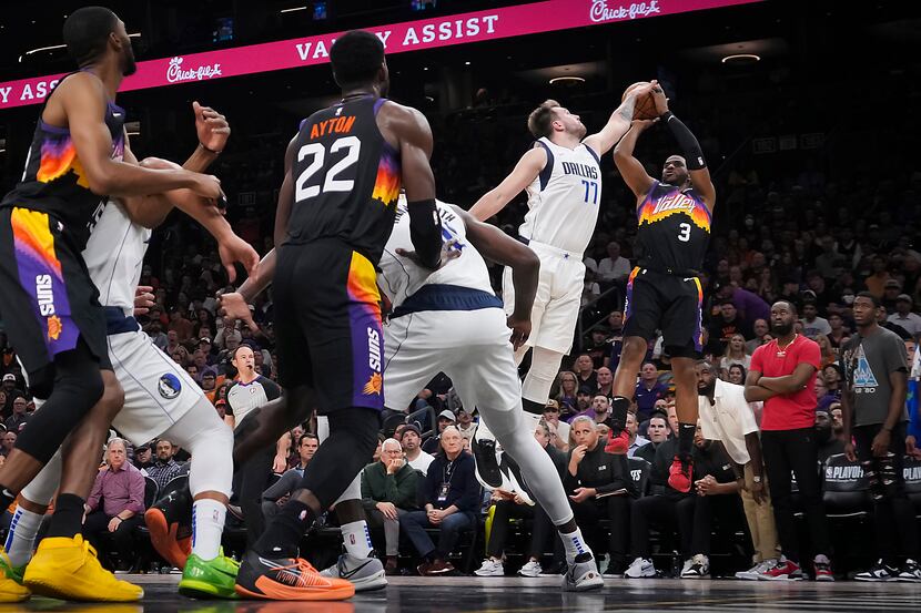 Dallas Mavericks guard Luka Doncic (77) blocks a shot by Phoenix Suns guard Chris Paul (3)...