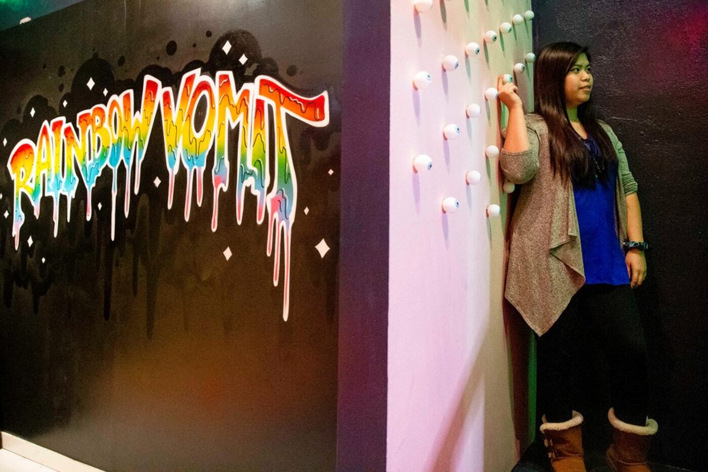 Renee Ng plays with an eyeball on a wall during a soft opening night at Rainbow Vomit on...