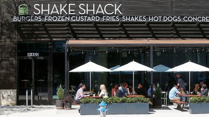 Diners eat lunch in the patio area at Shake Shack that opens its store in the mixed-use...